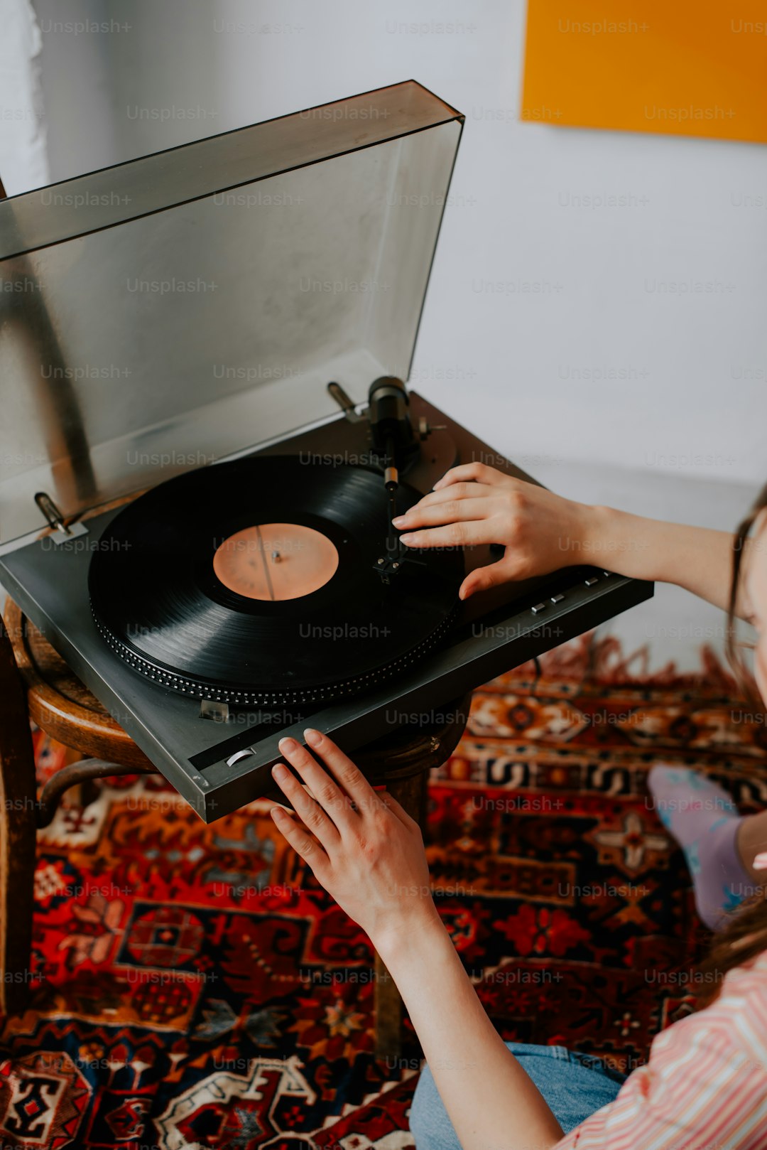 a woman holding a record player in her hands