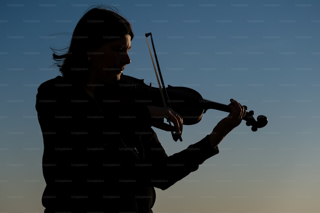 a woman holding a violin in her hands