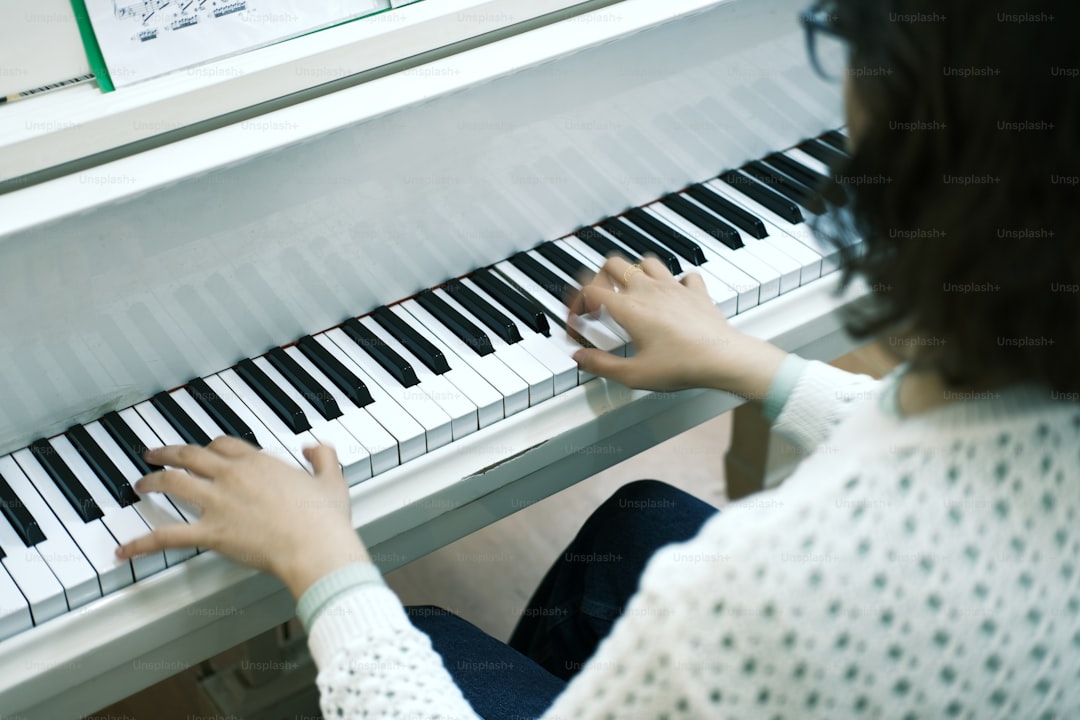 a woman is playing a piano with her hands