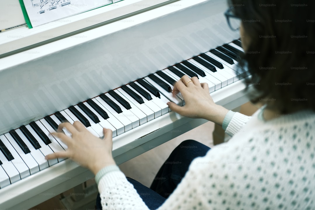 a woman is playing a piano with her hands