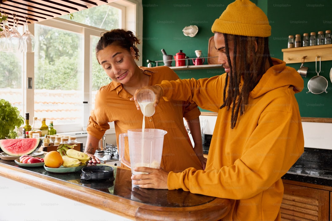 a woman pouring a drink into a blender