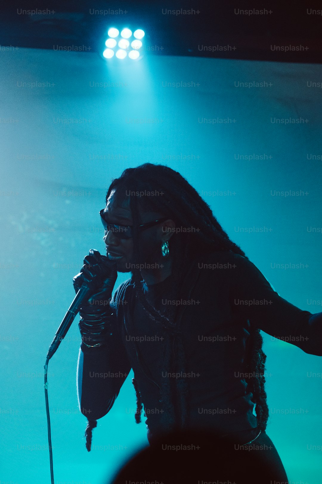 a woman singing into a microphone on stage