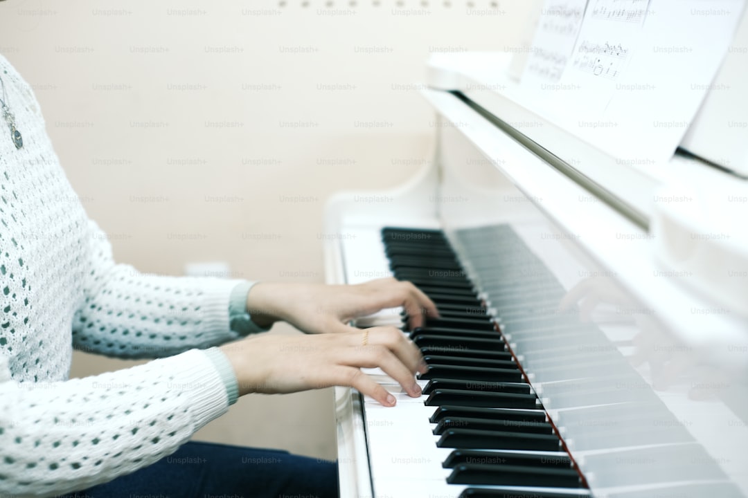 a woman sitting at a piano playing the piano