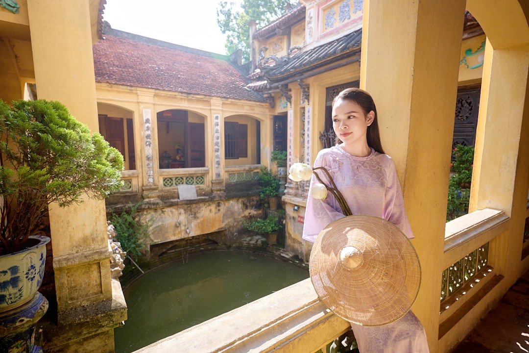 A woman standing on a balcony holding a basket