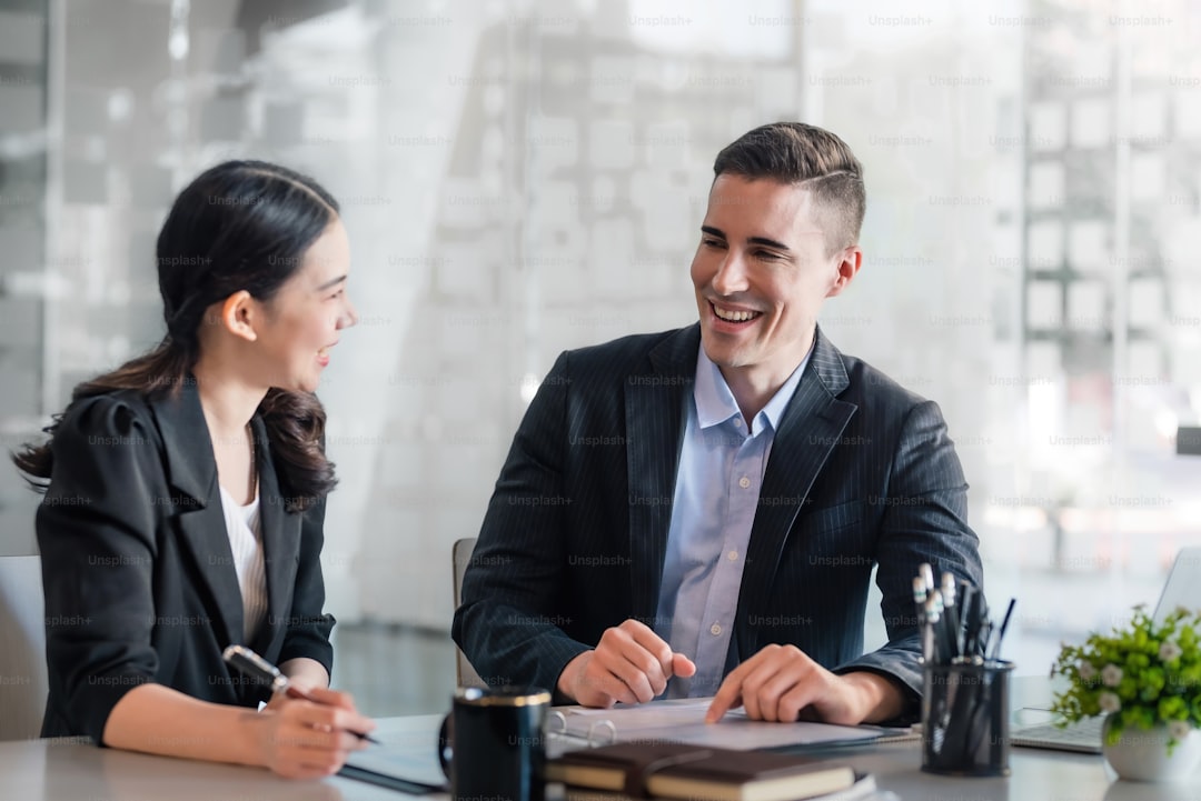 Businessman and businesswoman work together at office.