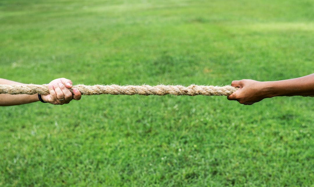 Closeup of hand pulling the rope in tug of war game