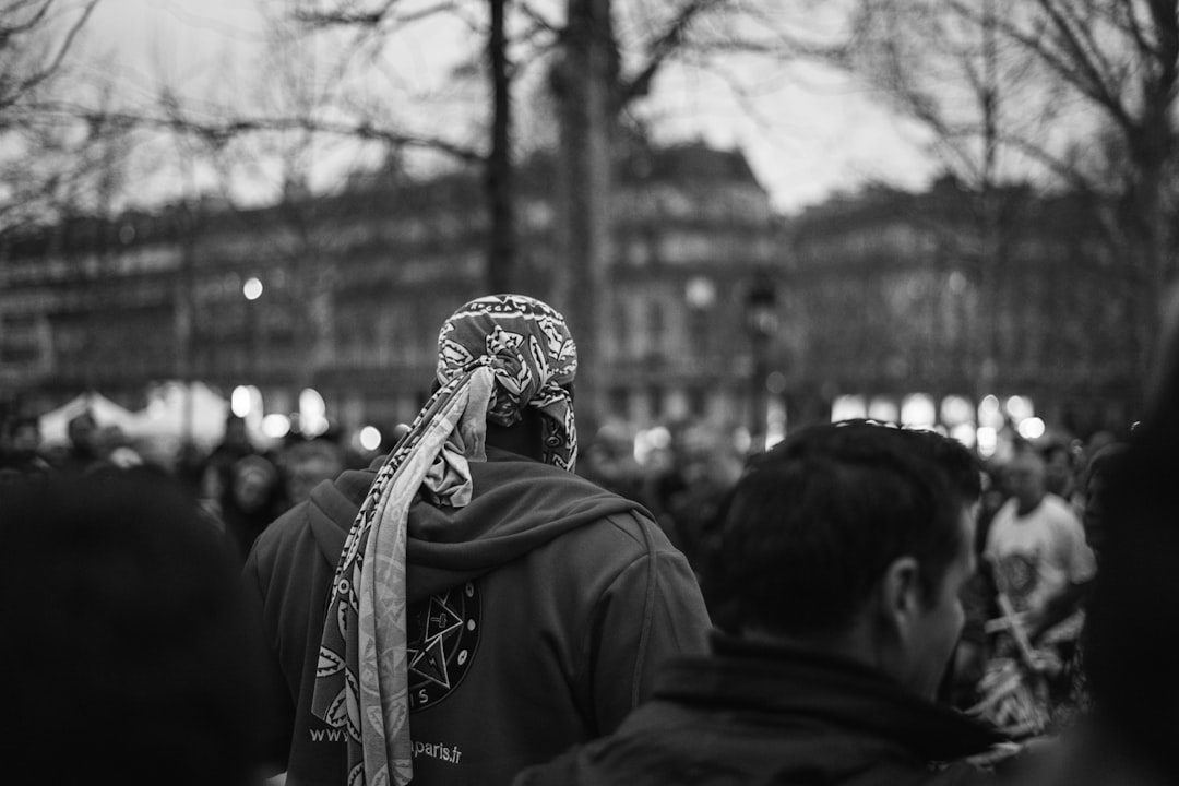 grayscale photo of man in hoodie with mask