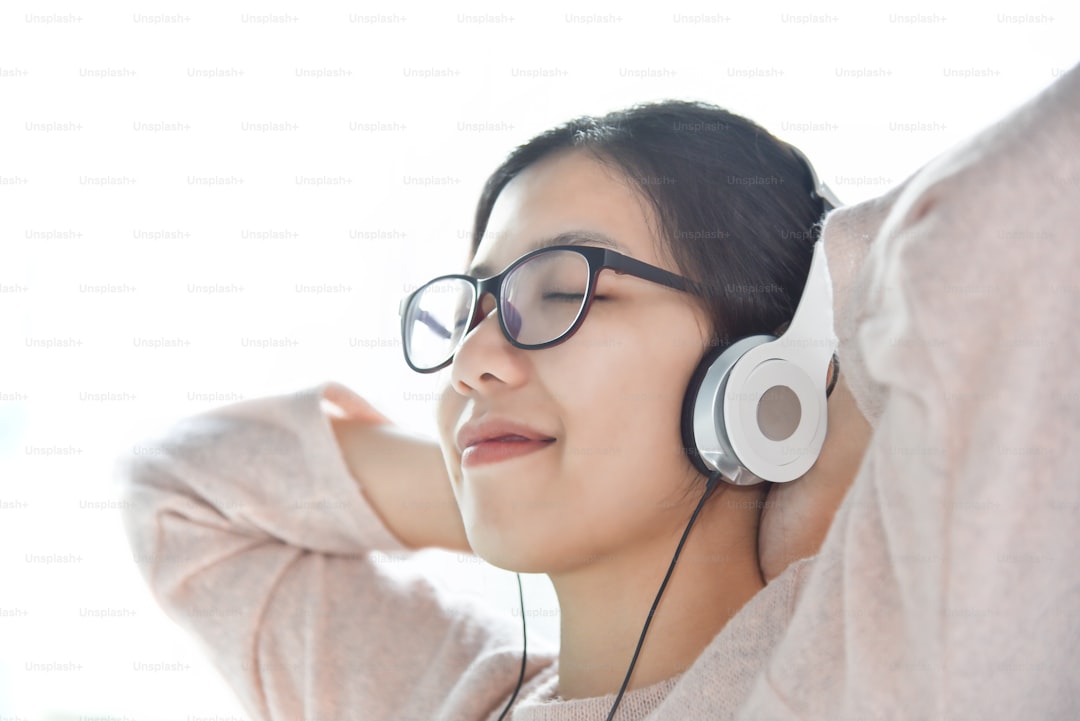 Happy Beautiful Asian woman listening to the music with headphone