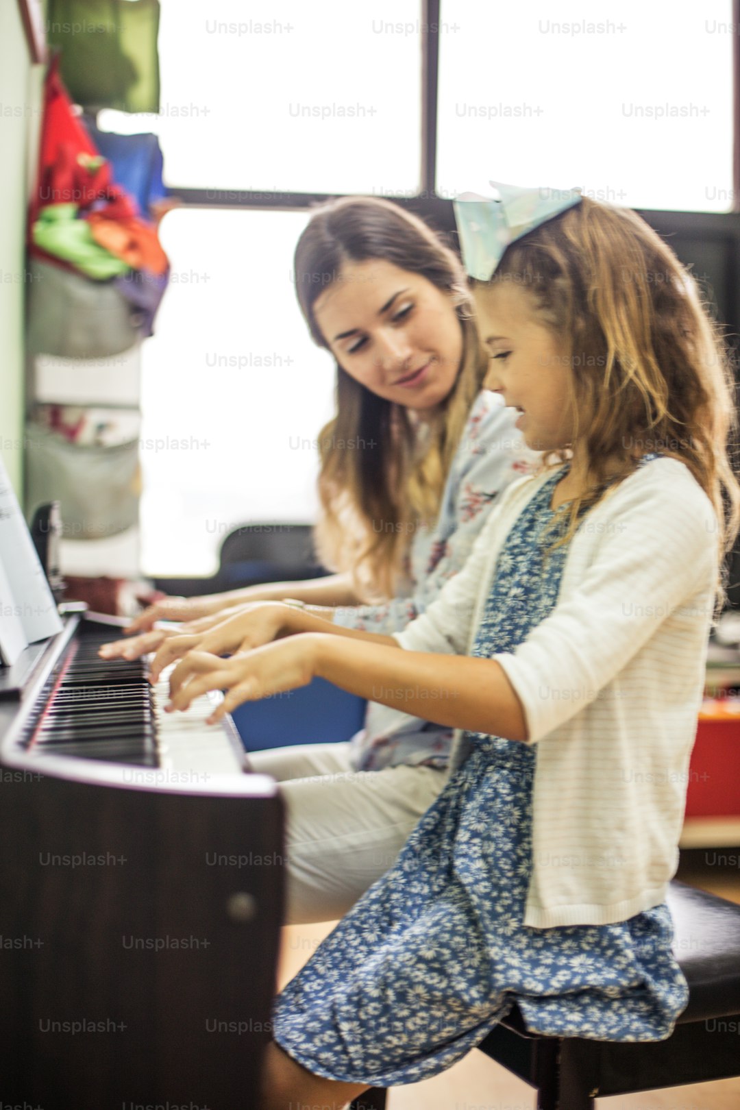 Learning the correct technique. Child in music school with teacher.