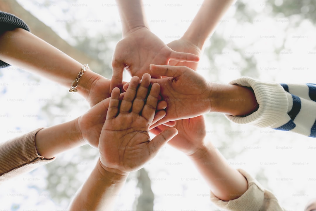 Low Angle View of young multiracial group of people Shaking hands