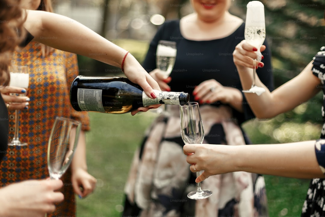 luxury elegant women at celebration drinking champagne in restaurant terrace