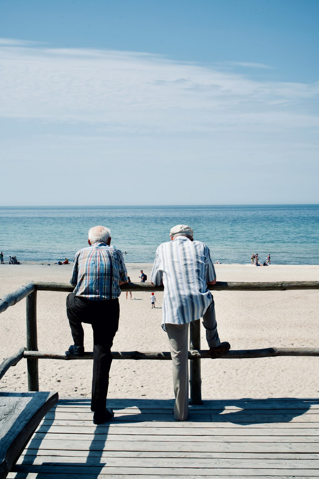 man and woman standing on beach during daytime