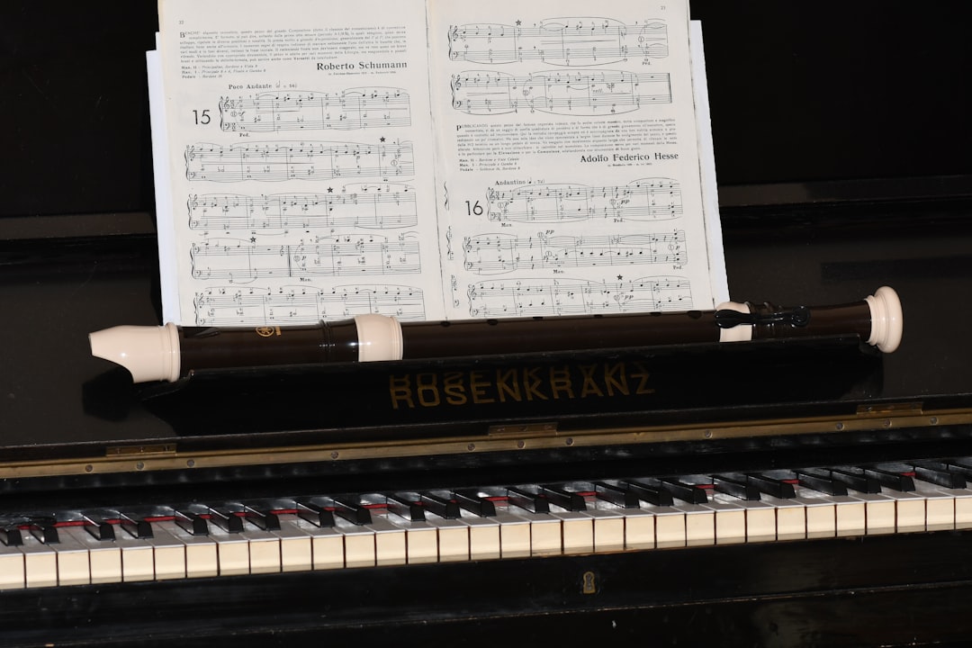 musical notes on brown upright piano