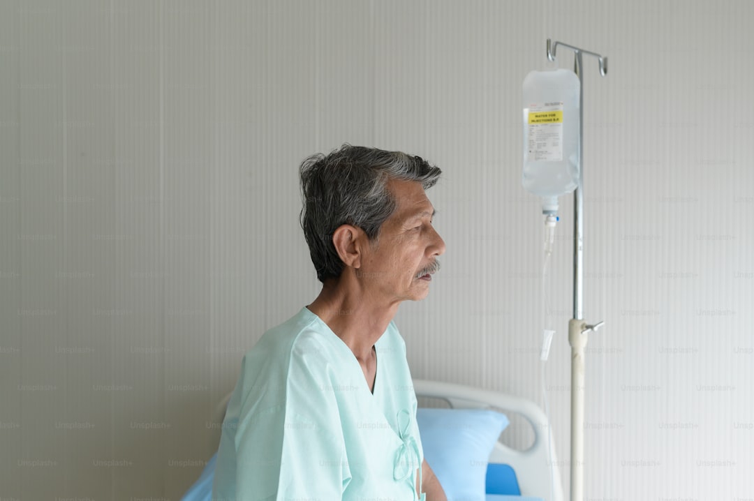 Portrait of senior patient lying on bed in hospital, healthcare and medical concept