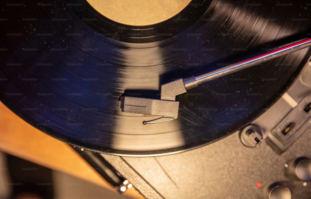 Retro sound technology, play vintage party music. Turntable vinyl record player, needle on the disc, close up top view.