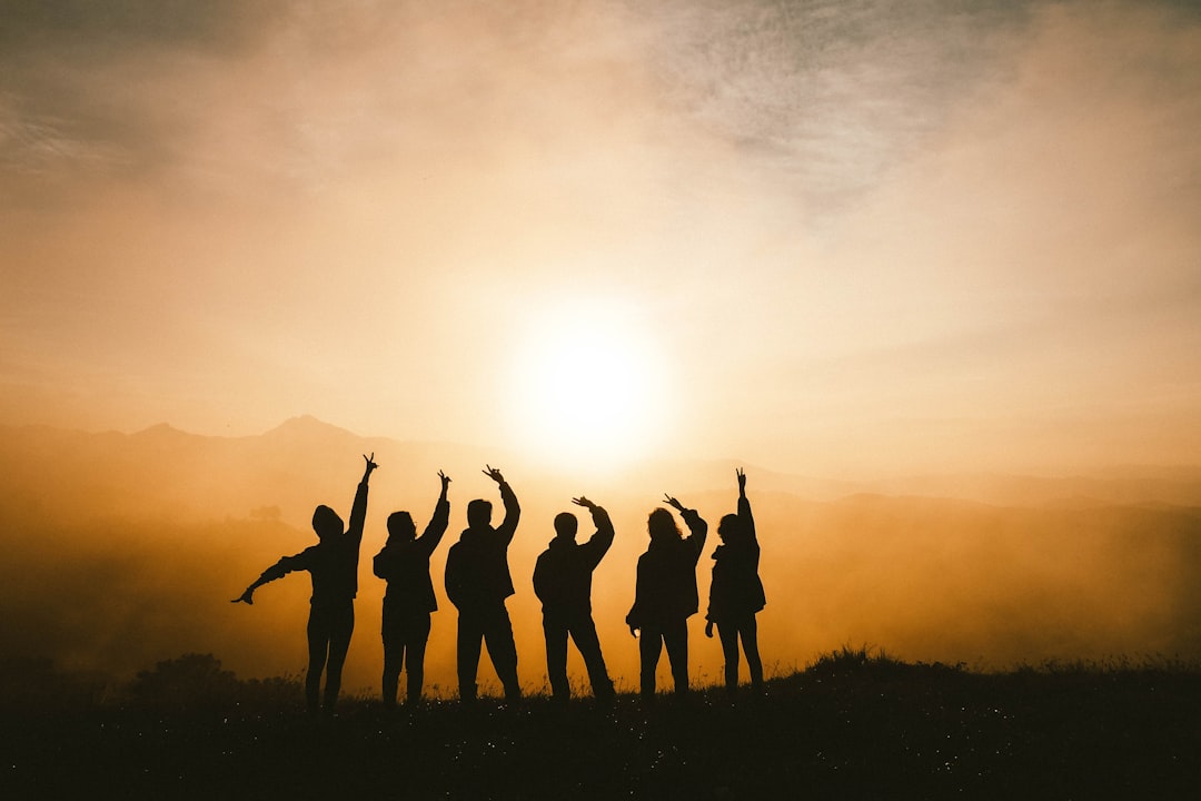 silhouette photo of six persons on top of mountain