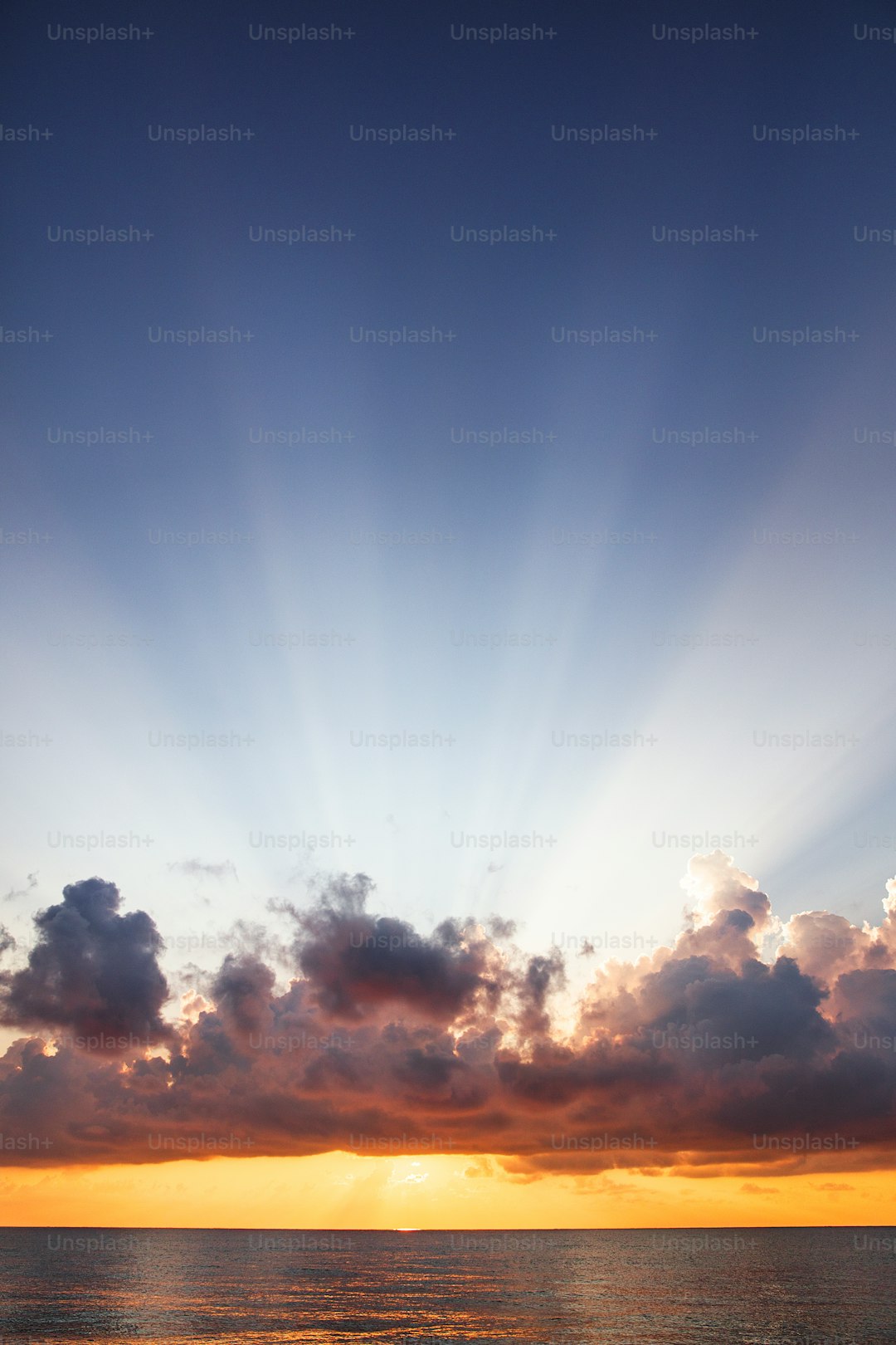 the sun is shining through the clouds over the ocean