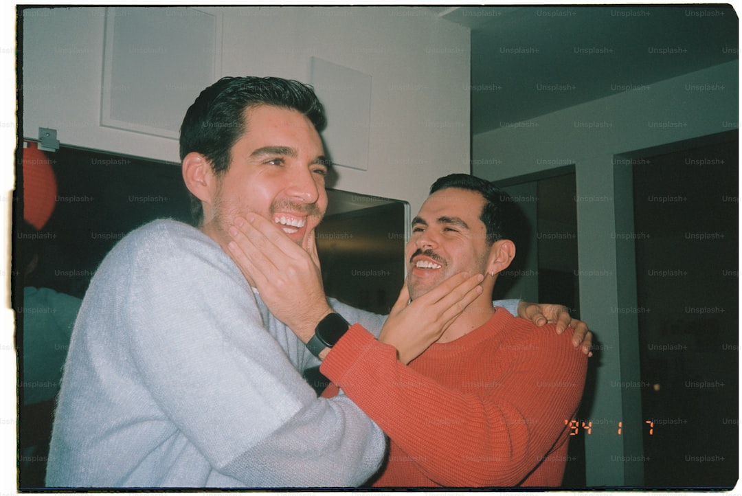 Two men are playfully interacting and laughing.