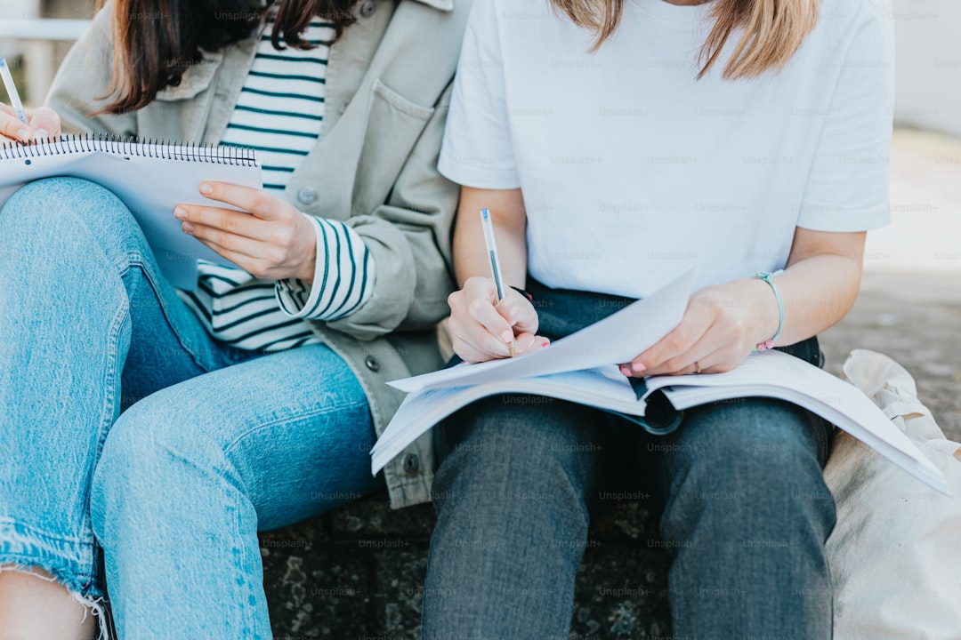 two women sitting next to each other on a bench