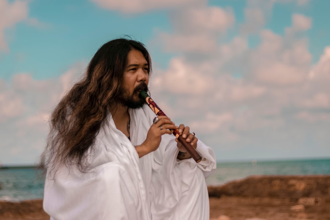 woman in white dress shirt playing flute